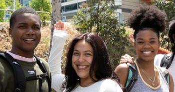three students smiling