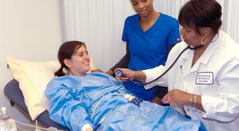 Medical Assisting instructor demonstrating procedure to students