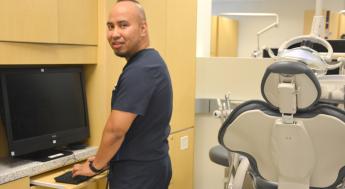 Dental assisting student working at computer station