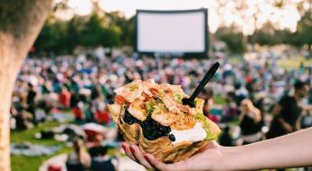 A crowd enjoying an outdoor movie