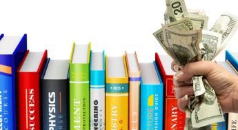 textbooks and fist holding cash