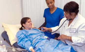 Medical Assisting instructor demonstrating procedure to students