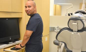 Dental assisting student working at computer station