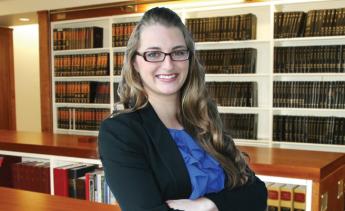 female paralegal standing in law library