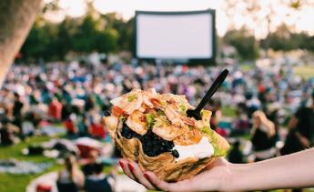 A crowd enjoying an outdoor movie