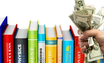 textbooks and fist holding cash