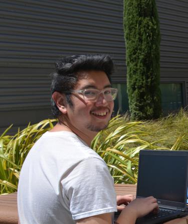 Smiling Student with Laptop