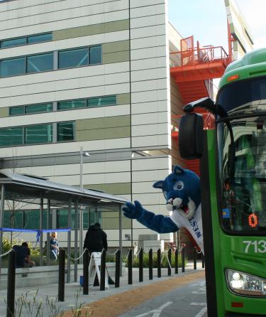 WLAC Mascot Costume Waving From a Bus