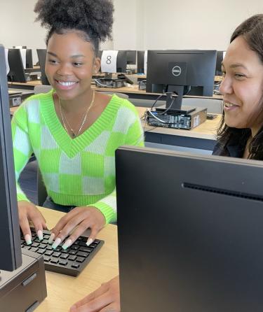 2 Females Working on a Computer
