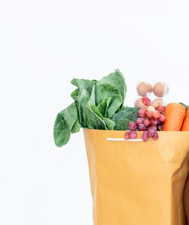 smiling student holding groceries