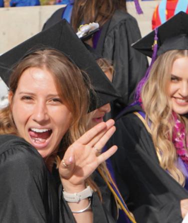 bachelors degree students in graduation gowns