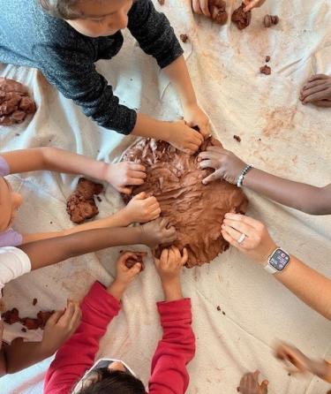 Children using clay as a way to self express.