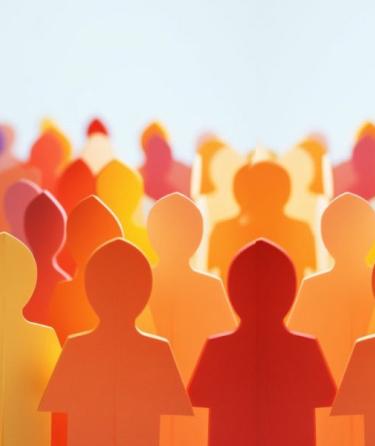 paper cut out people in a variety of colors