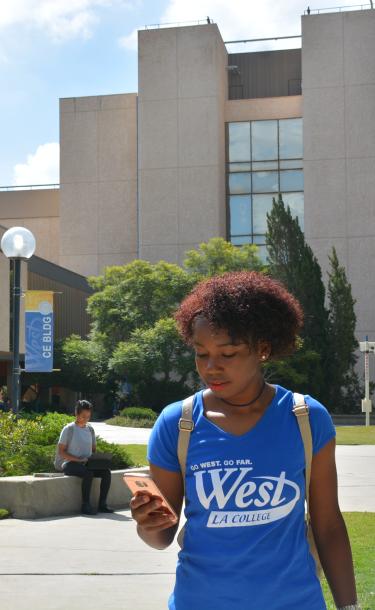 Woman on Campus With Cell Phone