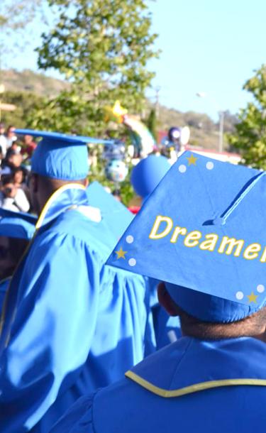 student with graduation cap that reads "Dreamer"