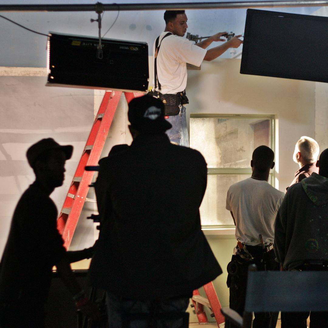 Filmer Student Working with Lights