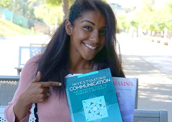 female student holding textbooks