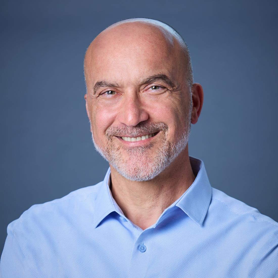 headshot of man smiling looking at the camera